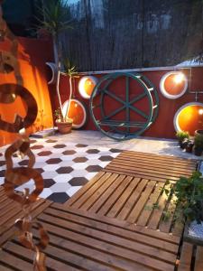 a patio with a wooden bench on a checkered floor at Melting Pot Rome in Rome