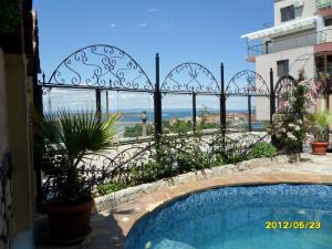 a swimming pool with a view of a building at Guest House Hetodon in Sozopol