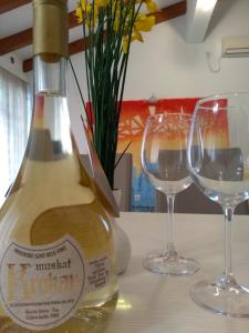 a bottle of wine and two glasses on a table at Apartmani Jovanovic in Petrovac na Moru