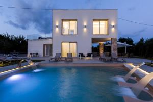 a villa with a swimming pool in front of a house at Scissure Sea Suite in Gaeta