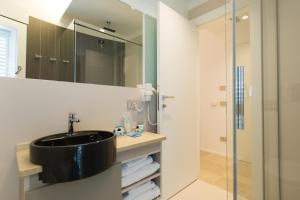 a bathroom with a black sink and a shower at Scissure Sea Suite in Gaeta