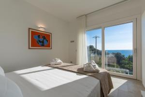 a bedroom with a bed and a large window at Scissure Sea Suite in Gaeta