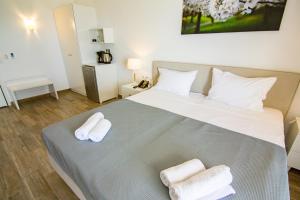 Postel nebo postele na pokoji v ubytování Blue Sea Hotel