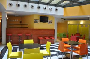 a dining room with colorful chairs and tables at City Central De Luxe in Prague