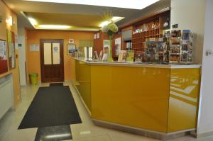 a lobby with a yellow counter in a store at City Central De Luxe in Prague