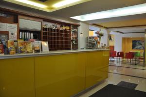 a restaurant with a yellow counter in a room at City Central De Luxe in Prague