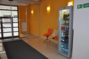 a room with a refrigerator and a chair in it at City Central De Luxe in Prague