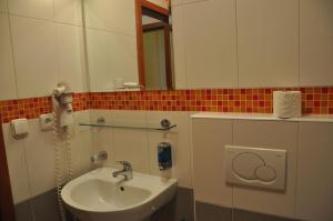 a bathroom with a sink and a mirror at City Central De Luxe in Prague