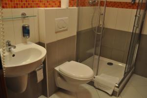 a bathroom with a toilet and a sink and a shower at City Central De Luxe in Prague