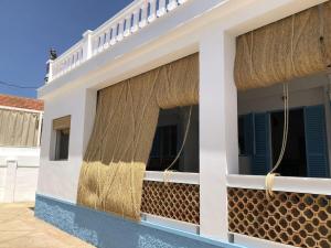 a house with curtains on the side of it at El Chalet in Punta Umbría