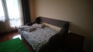 a couch with two pillows on it in a room at Apartament Relax in Sovata