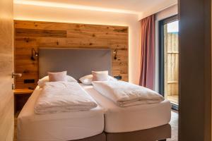 Letto o letti in una camera di Stadtvilla Schladming Boutiquehotel
