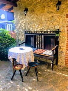 a table and chairs in front of a fireplace at Garden House in Ciorogârla