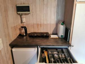a small kitchen with a stove and a refrigerator at Holmset Camping and Fishing in Namdalseid