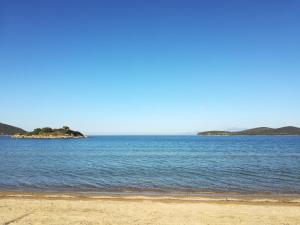 a large body of water with an island in the distance at Sea View Apartments Nikos in Nea Peramos