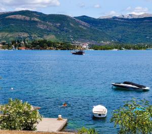 two boats in a large body of water at Luxury Apartment Maja in Tivat