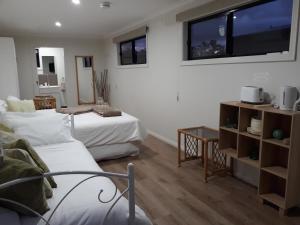 a bedroom with two beds and a tv on the wall at Aligning Health Retreat & Day Spa in Axedale