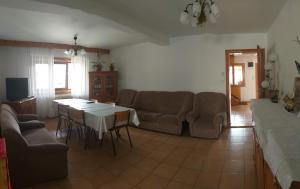 a living room with a couch and a table at Casa Rodica str. Clabucetului 28 in Buşteni