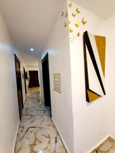 a hallway with a marble floor and stars on the wall at CG Apartments Metro in Ikeja