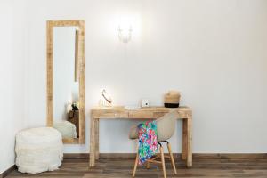 a dressing table with a mirror and a chair at Alexandra Beach Spa Resort in Potos