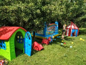 a group of play structures in the grass at Garden House in Ciorogârla +38 photos
