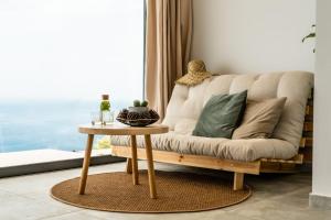 a living room with a couch and a table at SECRET HILL in Athani
