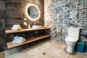 a bathroom with a toilet and a sink and a mirror at SECRET HILL in Athani