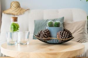 a table with a bowl of pine cones and a bottle of water at SECRET HILL in Athani
