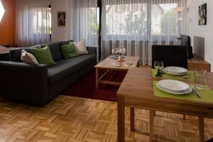 a living room with a couch and a table at Gästehaus Tannenhof in Bad Bergzabern