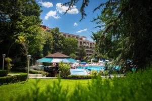 a resort with a swimming pool and a hotel at Park Hotel Perla in Golden Sands