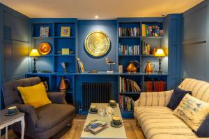 a blue living room with a couch and a table at Marazion Hotel in Marazion
