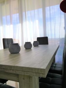 une table en bois avec trois bols au-dessus dans l'établissement Casa Gran mirador, 200 m2 ,Vistas al mar y WiFi, PEÑISCOLA, à Peñíscola