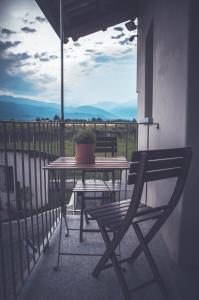 a table and a chair on a balcony with a view at Amaranto Bed & Breakfast in Cavour