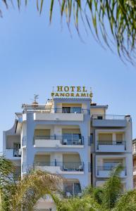a large white building with a blue sky at Hotel Panoramic in Giardini Naxos