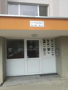 a building with white doors and a sign above it at Comfortable 2-bedroom apartment in Burgas