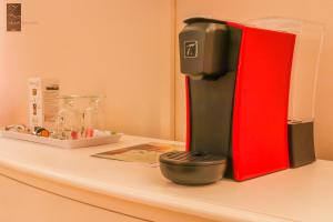 a red and black coffee maker sitting on a counter at Villa Zawaia B&B in Lagos
