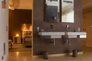 a bathroom with two sinks and a bedroom at Villa Zawaia B&B in Lagos