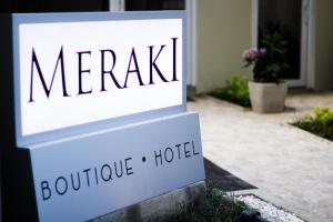 a sign for a hotel in front of a house at Meraki Boutique Hotel in Guatemala