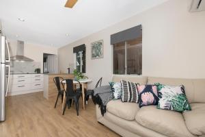 a living room with a couch and a table at Cosy 2 bedroom home in Townsville