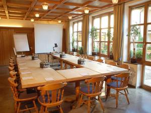 a large conference room with a large wooden table and chairs at Hotel Lamm in Höchberg