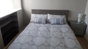 a bedroom with a bed with a heart bedspread and pillows at Sawel view Apartments in Dungiven