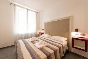 a hotel room with two beds and two lamps at Guest House Al Conservatorio in Rome