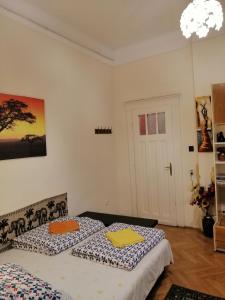 a bedroom with a bed, a desk, and a painting on the wall at Garibaldi 5 Apartments & Rooms in Budapest
