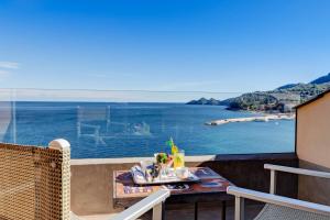 a balcony with a table and a view of the ocean at Hotel Continental in Santa Margherita Ligure