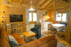 a living room with a couch and a dining room at Ferienhaus Bayern in Stamsried