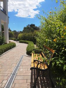 a park bench sitting on a brick walkway at Villa Anja in Peroj