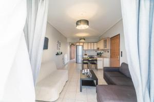 a living room with a couch and a table at John's Apartments in Karistos