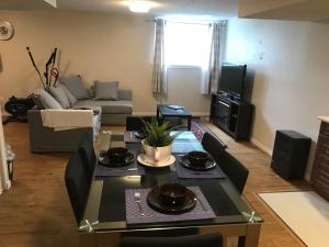 sala de estar con mesa y sofá en Self check-in spacious apartment with full Kitchen en Ottawa