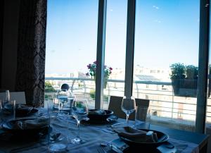 a table with wine glasses and a view of the city at Couple's Getaway in Is-Swieqi