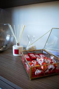 a table with a box of chocolates and a vase at Couple's Getaway in Is-Swieqi
